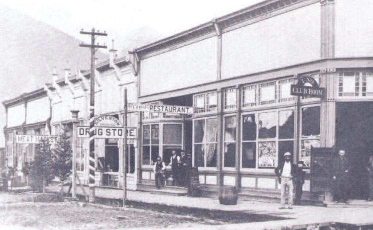 The west side of the 1100 block of Greene Street in 1891. In front, at the corner of 12th and Greene, is the Uno Club Room, followed by the St. Charles Restaurant, Neer &amp; Hanna Barbers, Silverton Drug Co., Helmboldt Meat Market, Bordeleau Hardware Co., and H.G. Prosser Furniture Store and Undertaking Parlor Photo courtesy San Juan County Historical Society
