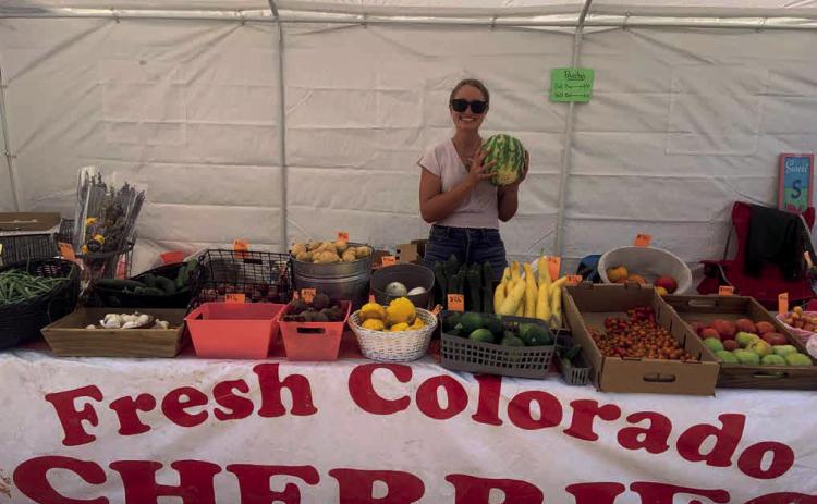Raelen Barr sells fresh produce at the Columbine Roadhouse M-F, 10-6pm Photo by Raelen Barr