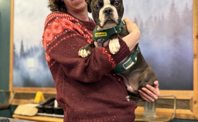 photo by DeAnne Gallegos Gina Rosato of Timberline Trading and her shop dog DOC