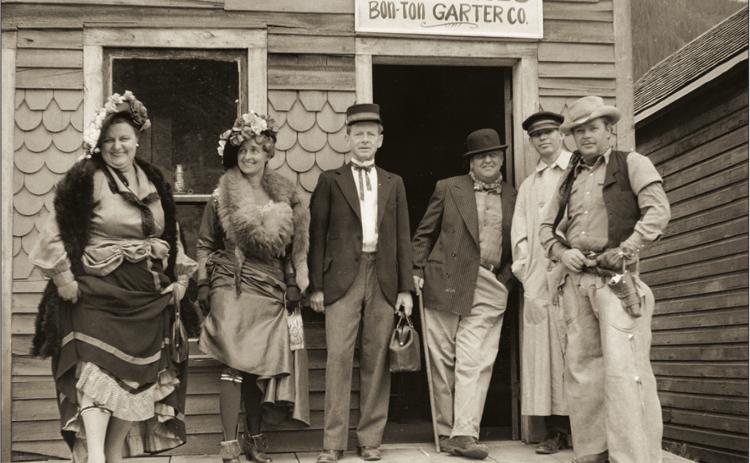 Photo Courtesy of: San Juan County Historical Society Costumed characters on Blair Street involved in promotion of tourist business along the street. Group of six is posed on the porch of the structure at 1154 Blair, owned at the time by the Bairds. Left to right: Sarah (Sally) Waddington, Betsy Baird, Gregory Greene, Ralph O. Baird, “Tulsa Kid” (name not cited), Ray Irwin. Photographer was Herold Waddington. So ... who was the Tulsa Kid?