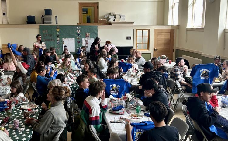 Students receive their school T -shirts at school holiday luncheon photo by Dr. Yvonne Naughton