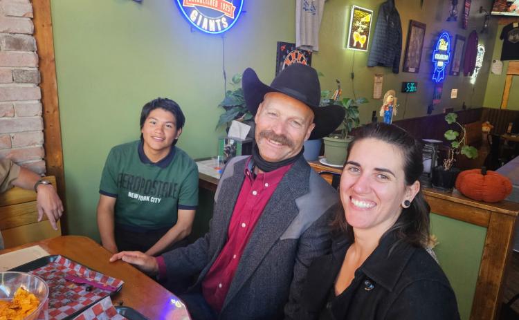Sheriff Lowrance’s son sitting with Dean and Bre Mize at the Alpine Tavern event on Sunday photo by Alpine Tavern
