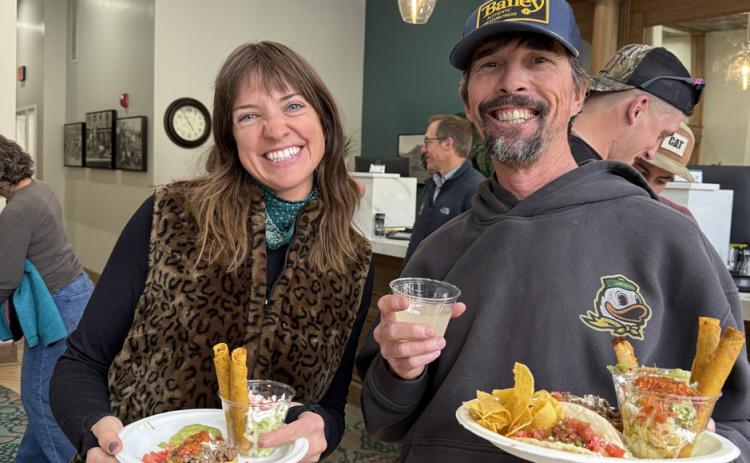 Holly Huebner and Paul Joyce enjoy local food truck High Altitude's tacos at the Citizens State Bank grand reopening party photo by DeAnne Gallegos