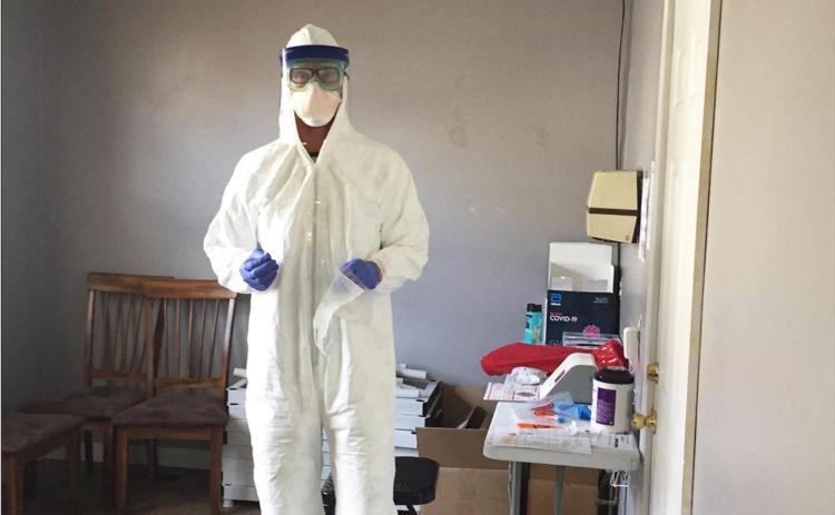 Silverton EMT Tyler George, in full personal protective equipment, ready to conduct a COVID-19 test.