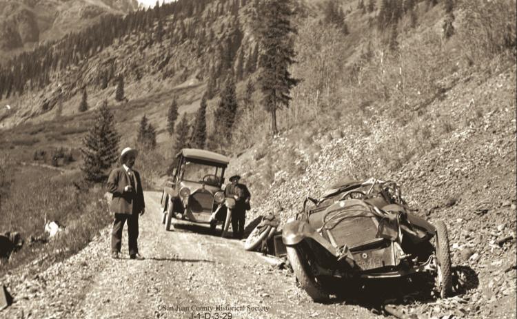 The wreckage of Will Ennis’ automobile on the roadway above Chattanooga. Two men are on the roadway. The man at right is Fred Patterson. The Ennis vehicle crashed on Wednesday, Oct. 5, 1921. Photo courtesy of San Juan County Historical Society