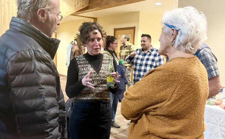 Elizabeth Stuffings chatting with San Juan County Commisioner Scott Fetchenheir &amp; com-munity member Sue Morris at candidate's night last December photo by DeAnne Gallegos