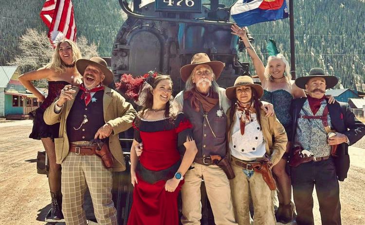 Group of western and Victorian characters pose with steam engine 476. Photo credit Misty French