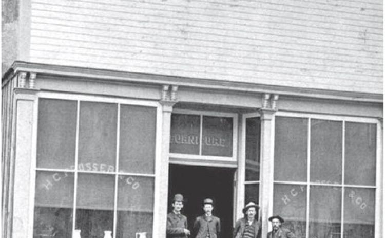 Photo courtesy of San Juan County Historical Society The Prosser Building at 1121 Greene Street was opened for business in June 1183, with Horace Greeley Prosser operating a furniture store and undertaker service. The building is now home to San Juan Sweets, next door to the Brown Bear Cafe. In the background can be seen the old wood-frame Silverton School which was building in 1884.