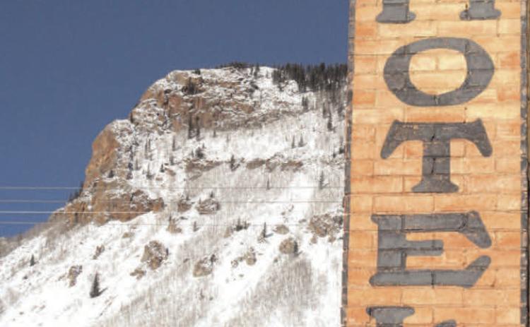 The Avon Hotel at the corner of Blair and 10th streets still advertises great rates, with snow-covered Anvil Mountain in the background. Photo: Mark Esper