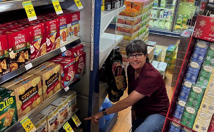 Charlie Monsalve shows off the new customer appreciation program. Photo Credit DeAnne Gallegos