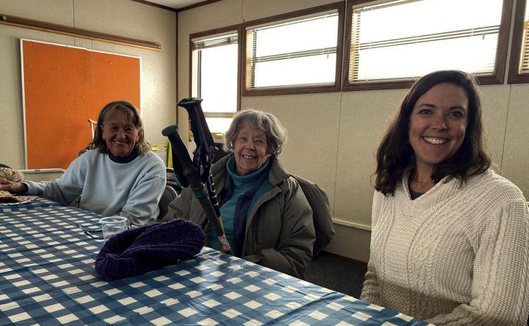 Seniors and volunteers sitting down together Photo provided by Becky Joyce