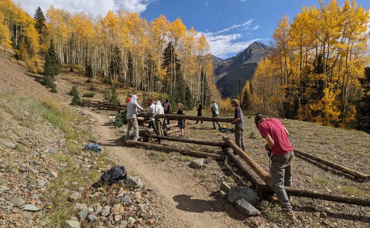 Building a fence amongst the fall colors on the Baker’s Park trail. Photo credit Silverton Singletrack Society