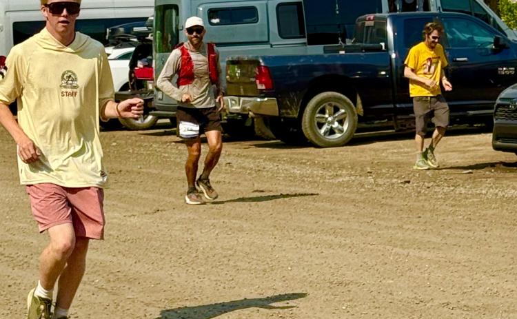 Silverton locals Phen and Steve Mead run with their longtime friend Ben Wyrick as he completes the Hardrock 100 photo by Missy Izard